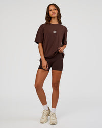 Woman wearing Everyday Elevation FLXCotton Oversized Tee - Hot Chocolate-Off White | Model:Dakota | Size:XS