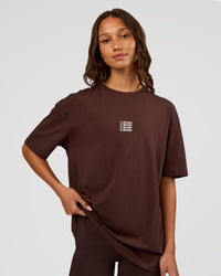 Woman wearing Everyday Elevation FLXCotton Oversized Tee - Hot Chocolate-Off White | Model:Dakota | Size:XS
