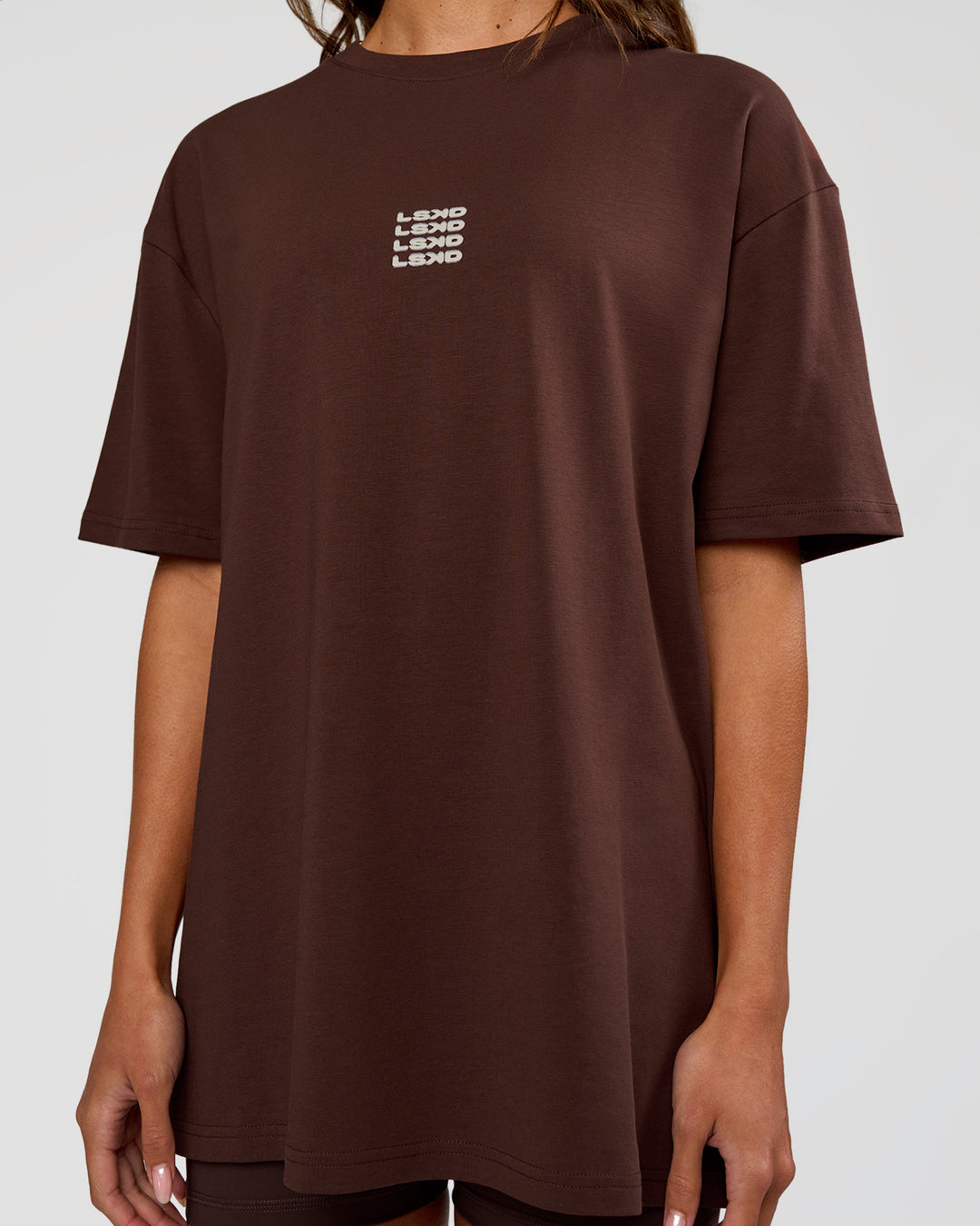 Woman wearing Everyday Elevation FLXCotton Oversized Tee - Hot Chocolate-Off White | Model:Dakota | Size:XS