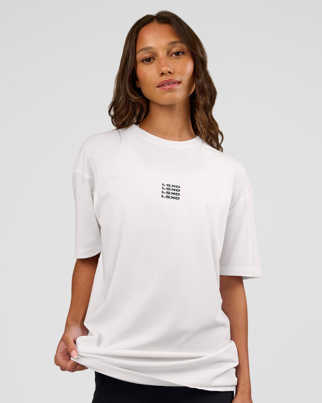 Woman wearing Everyday Elevation FLXCotton Oversized Tee - White-Carbon Green | Model:Dakota | Size:XS