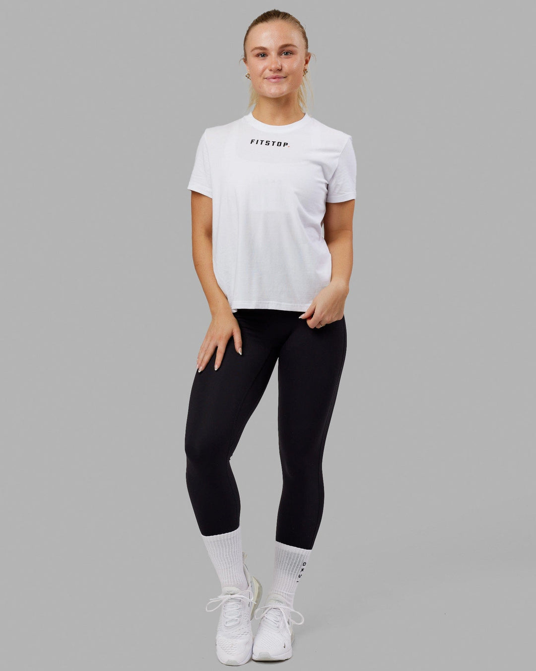 Woman wearing Fitstop Fast Tee - White