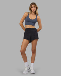 Woman wearing Flash Longline Sports Bra - Night Shadow | Model:Leilani | Size:XS