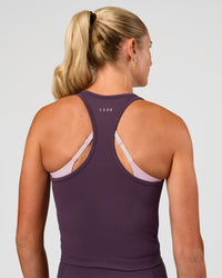 Woman wearing Flow Performance Tank 2.0 - Midnight Plum | Model:Emelia | Size:XS