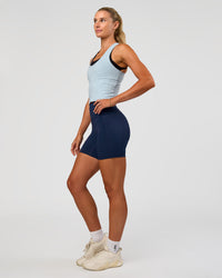 Woman wearing Flow Scoop Neck Performance Tank - Blue Aura | Model:Emelia | Size:XS
