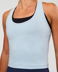 Woman wearing Flow Scoop Neck Performance Tank - Blue Aura | Model:Emelia | Size:XS