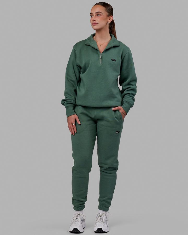Woman wearing Unisex Fundamental Track Pant - Dark Forest