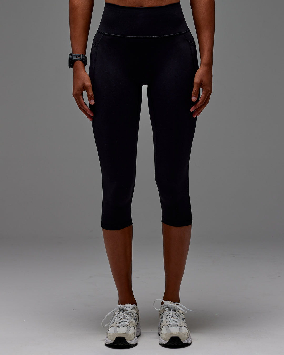 Woman wearing Fusion Ultra High-Rise 3/4 Legging Pockets - Black | Model:Txai | Size:XS