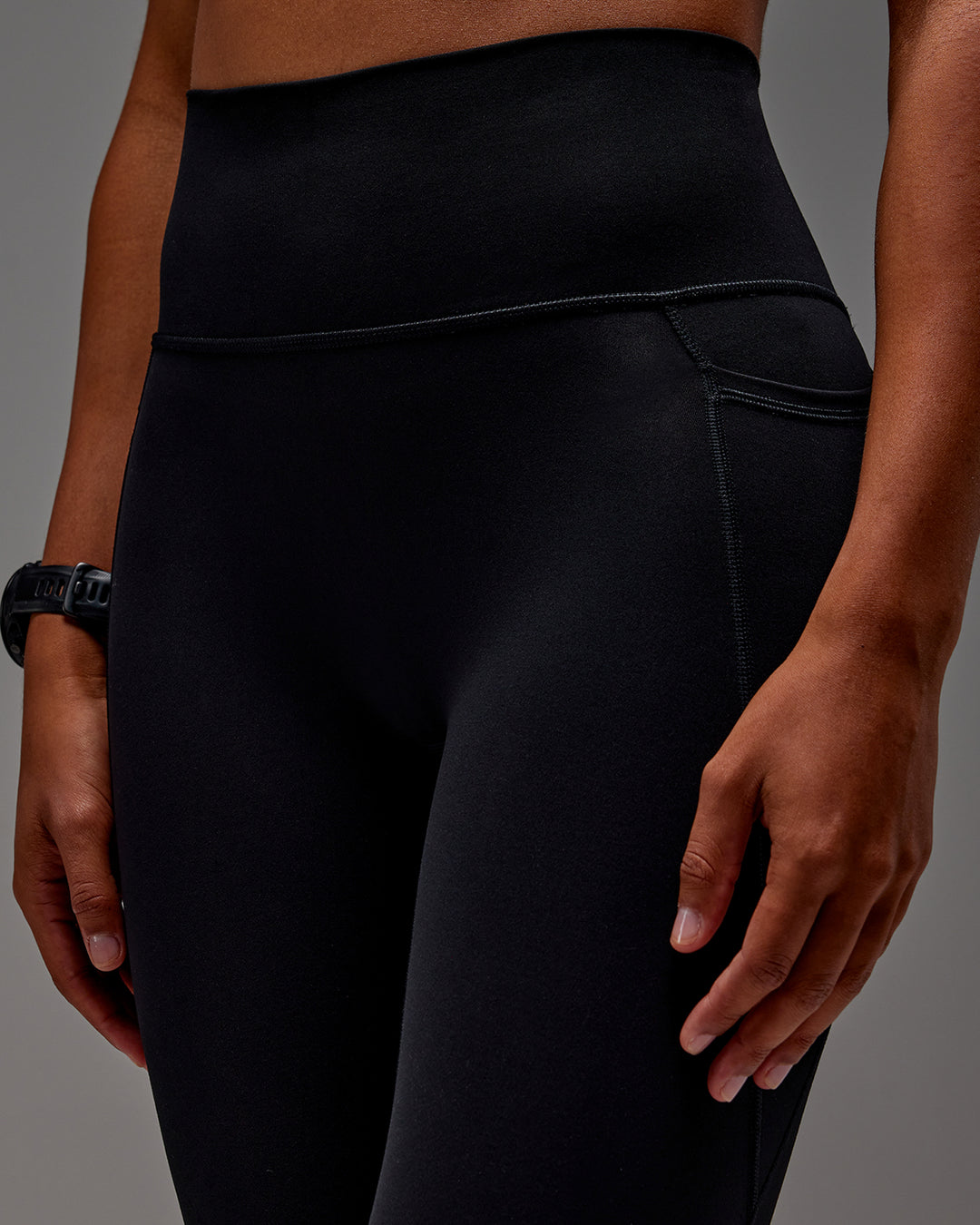 Woman wearing Fusion Ultra High-Rise 7/8 Legging Pockets - Black | Model:Txai | Size:XS