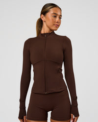 Woman wearing Fusion Active Jacket - Hot Chocolate | Model:Charli | Size:XS