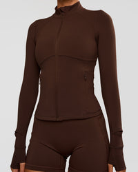 Woman wearing Fusion Active Jacket - Hot Chocolate | Model:Charli | Size:XS