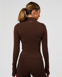 Woman wearing Fusion Active Jacket - Hot Chocolate | Model:Charli | Size:XS