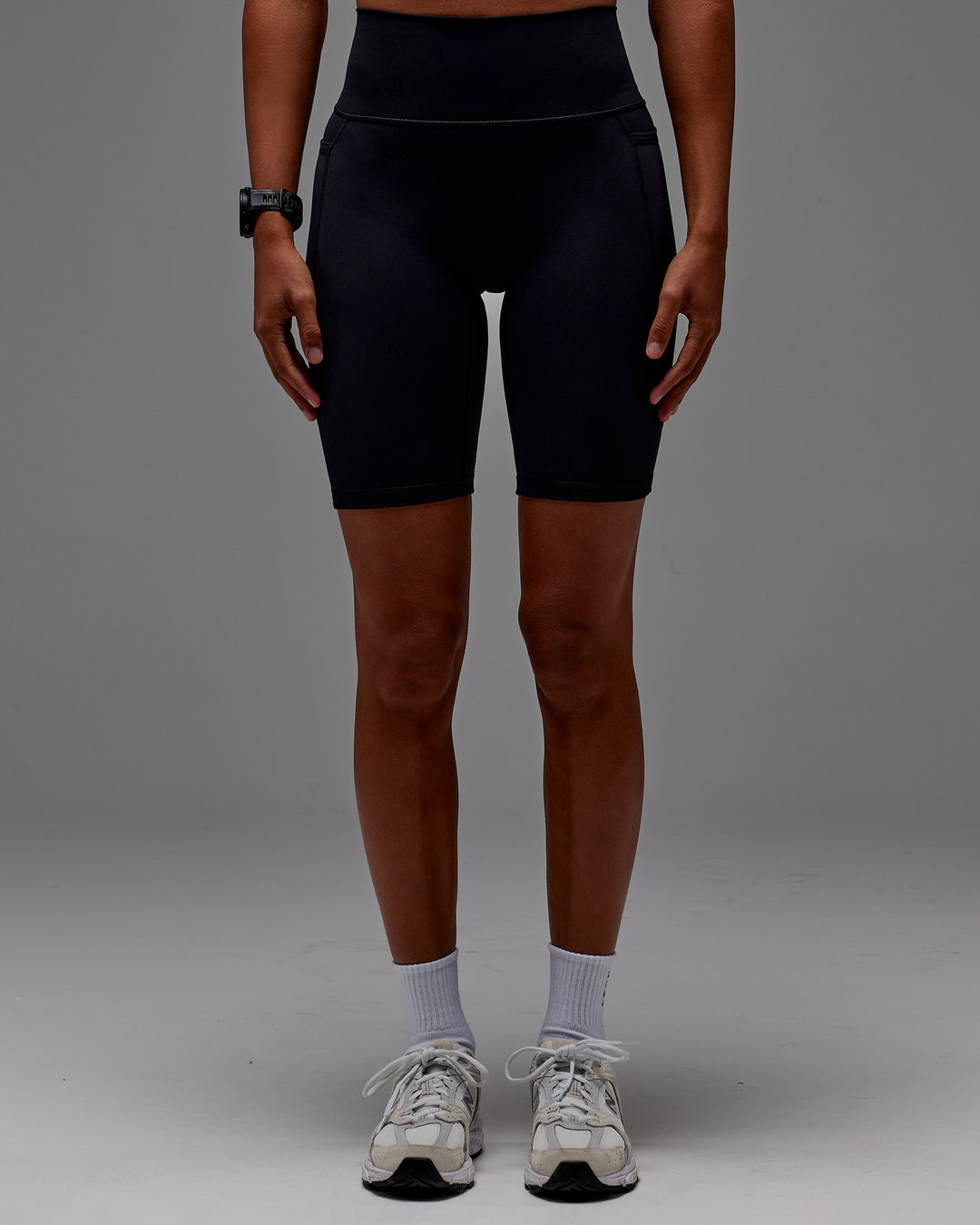 Woman wearing Fusion Ultra High-Rise 9&quot; Short Pockets - Black | Model:Txai | Size:XS