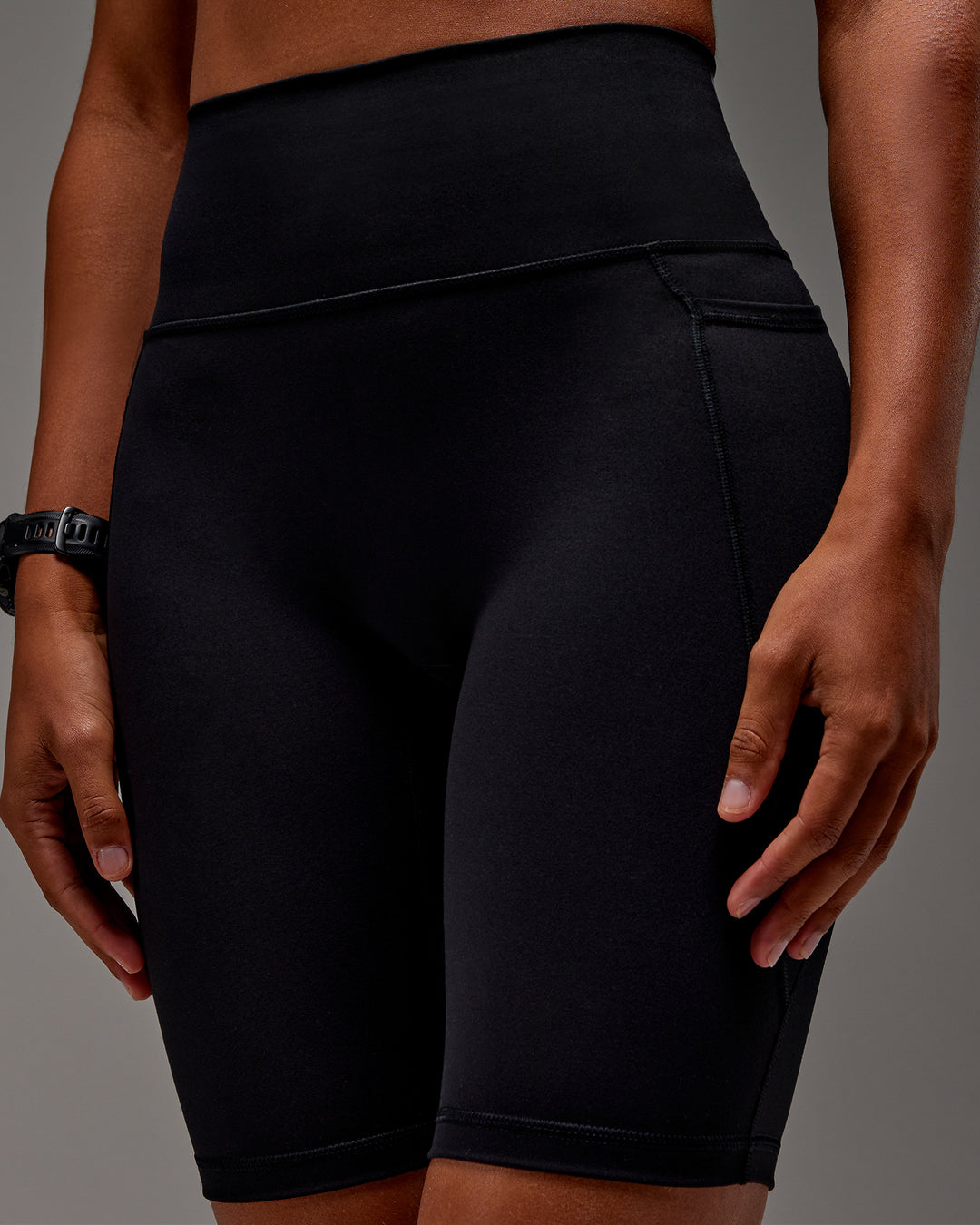 Woman wearing Fusion Ultra High-Rise 9&quot; Short Pockets - Black | Model:Txai | Size:XS