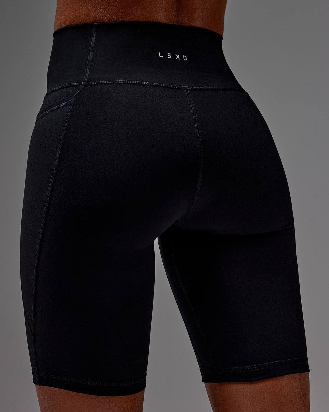 Woman wearing Fusion Ultra High-Rise 9&quot; Short Pockets - Black | Model:Txai | Size:XS