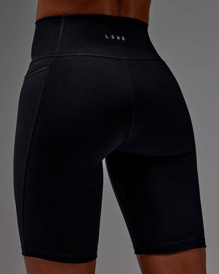 Woman wearing Fusion Bike Short With Pockets in Black | Model:Txai | Size:XS
