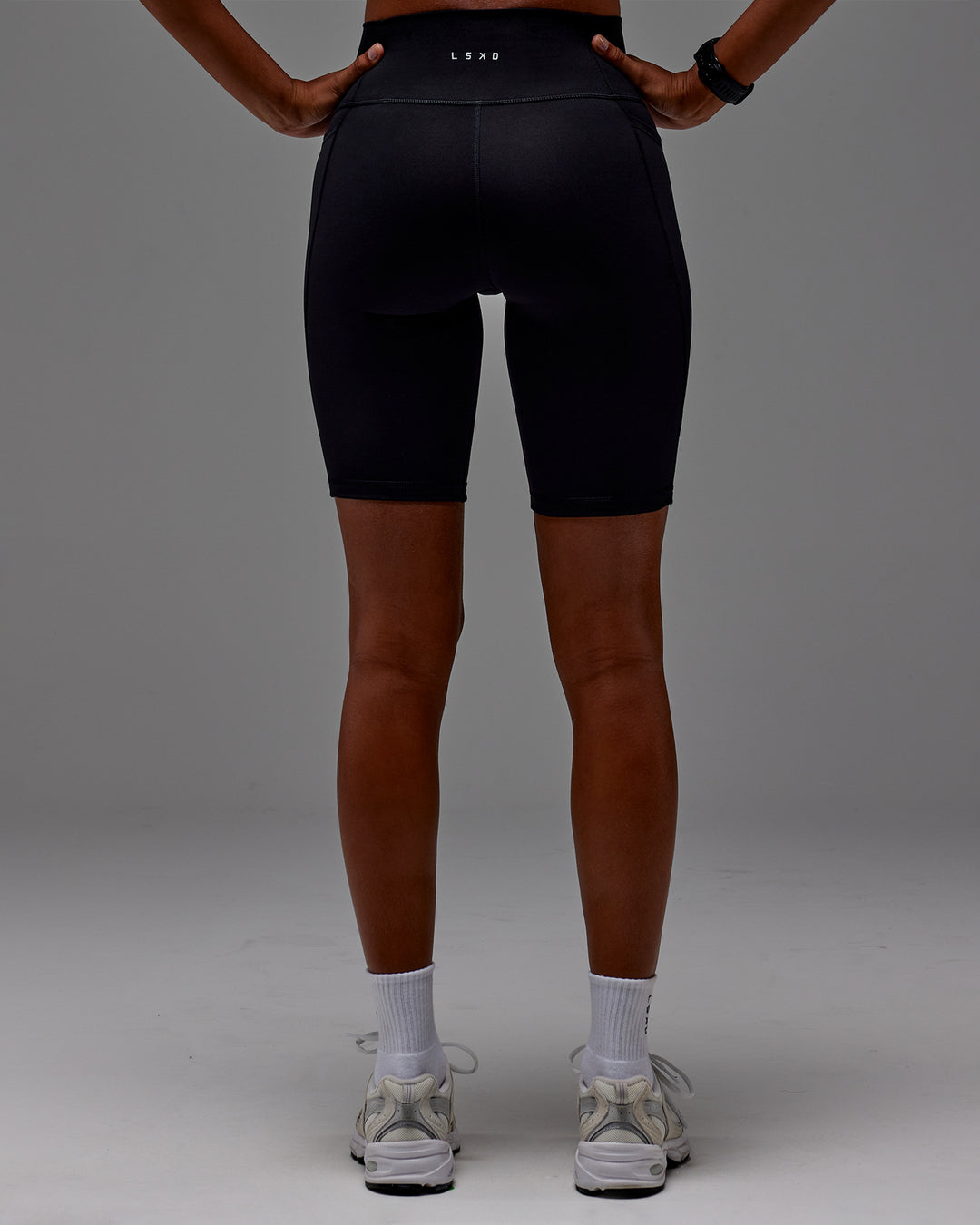 Woman wearing Fusion Ultra High-Rise 9&quot; Short Pockets - Black | Model:Txai | Size:XS