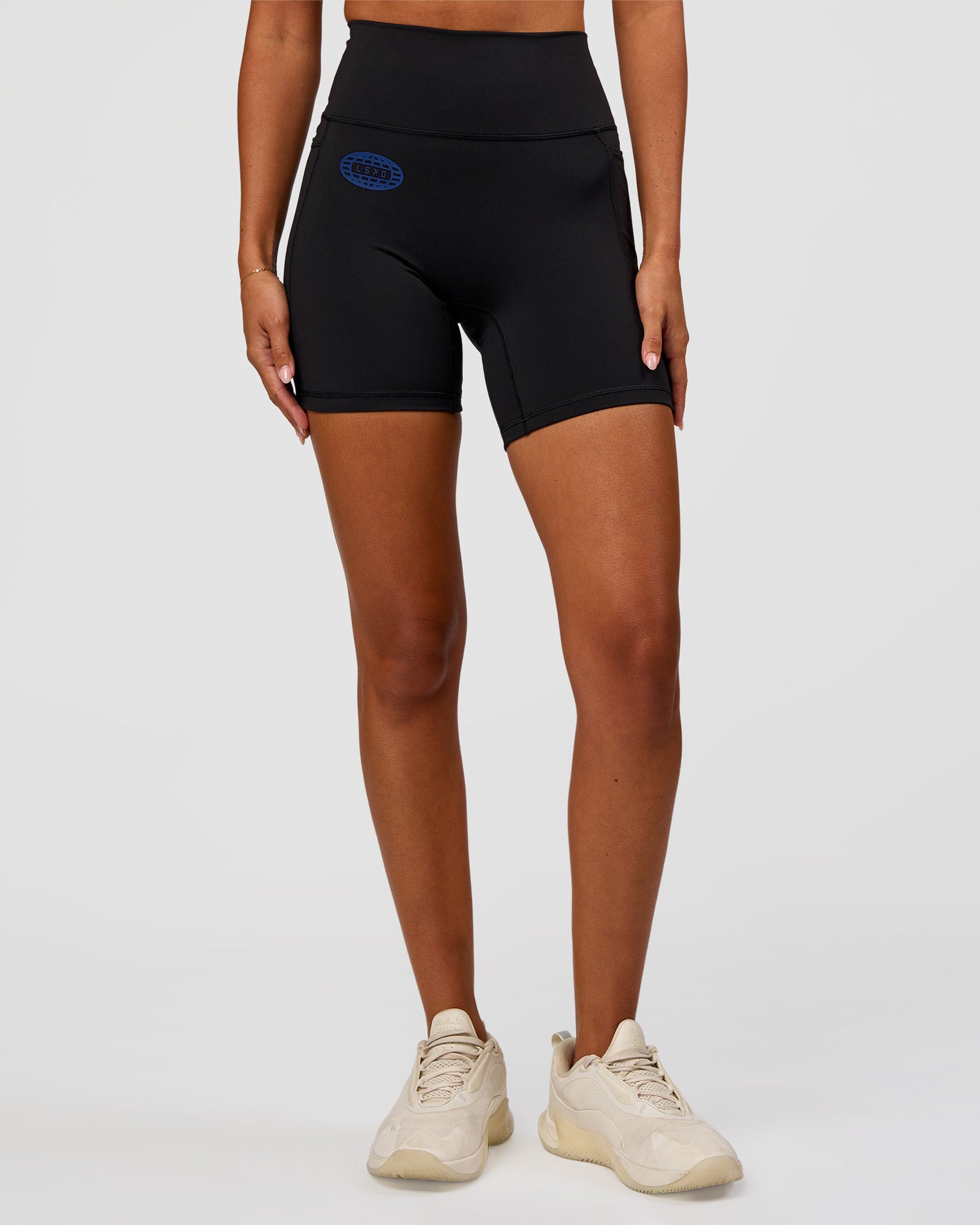 Woman wearing Fusion Hype Graphic Ultra High-Rise 6" Short Pockets - Black-Electric Indigo | Model:Charli | Size:XS