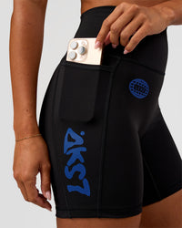 Woman wearing Fusion Hype Graphic Ultra High-Rise 6" Short Pockets - Black-Electric Indigo | Model:Charli | Size:XS
