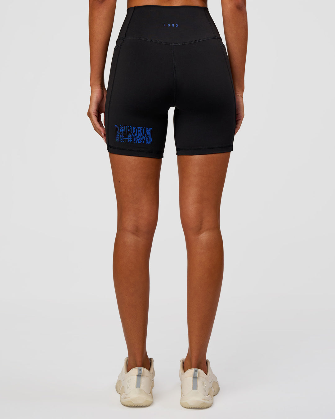 Woman wearing Fusion Hype Graphic Ultra High-Rise 6" Short Pockets - Black-Electric Indigo | Model:Charli | Size:XS