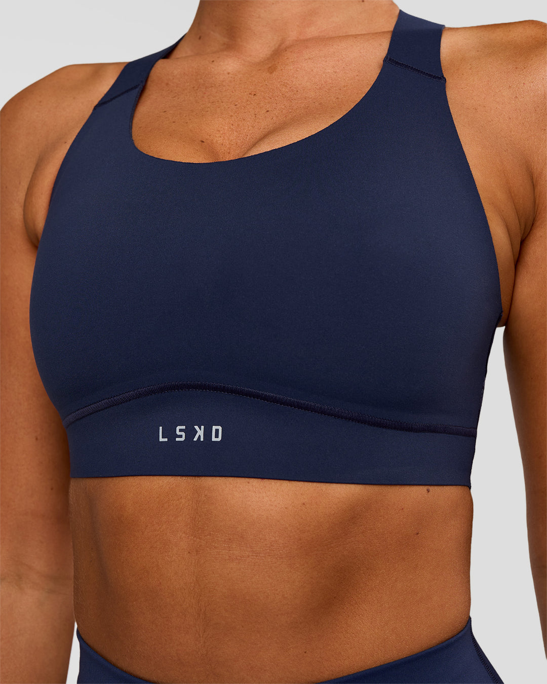 Woman wearing Fusion Sports Bra 2.0 - Future Navy | Model:Charlie | Size:S