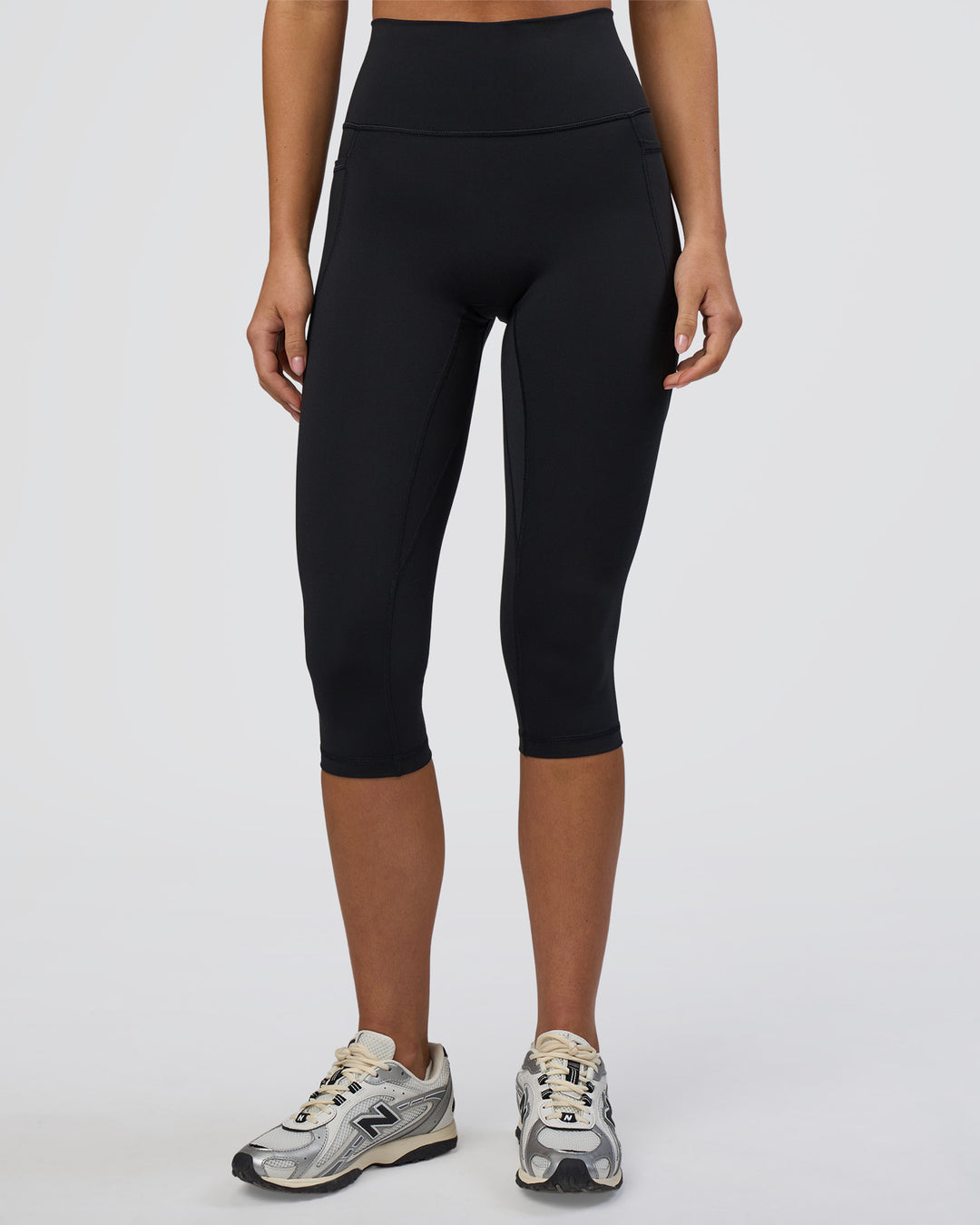 Woman wearing Fusion Ultra High-Rise 3/4 Legging Pockets - Black | Model:Eliza | Size:XS