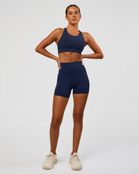 Woman wearing Fusion Ultra High-Rise 4" Short - Future Navy | Model:Charli | Size:XS