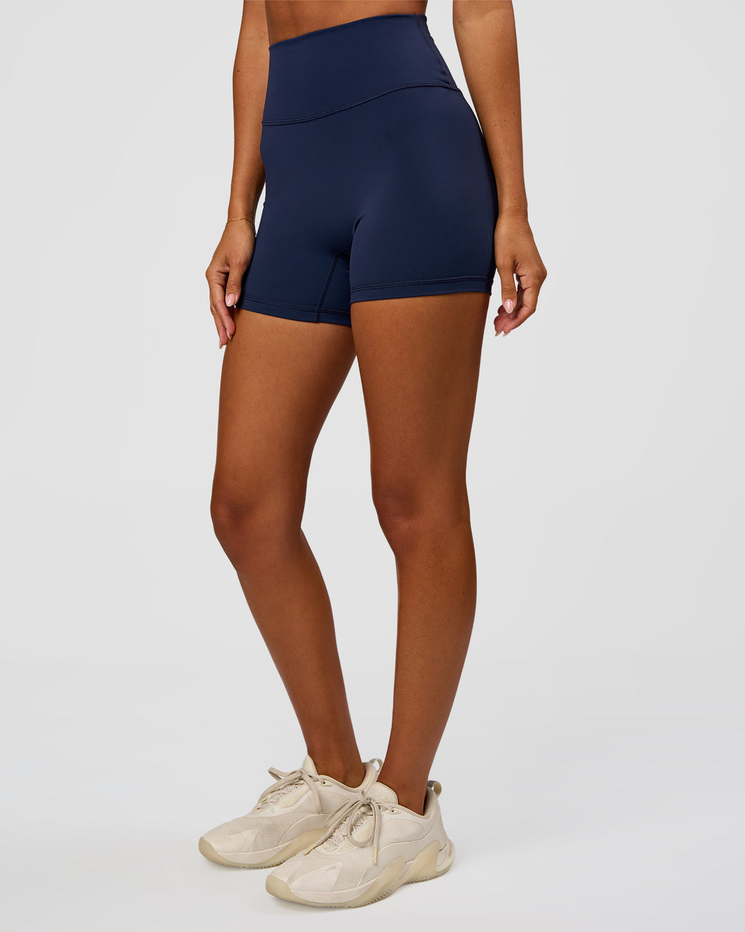 Woman wearing Fusion Ultra High-Rise 4" Short - Future Navy | Set:true | Angle:side | Model:Charli | Size:XS