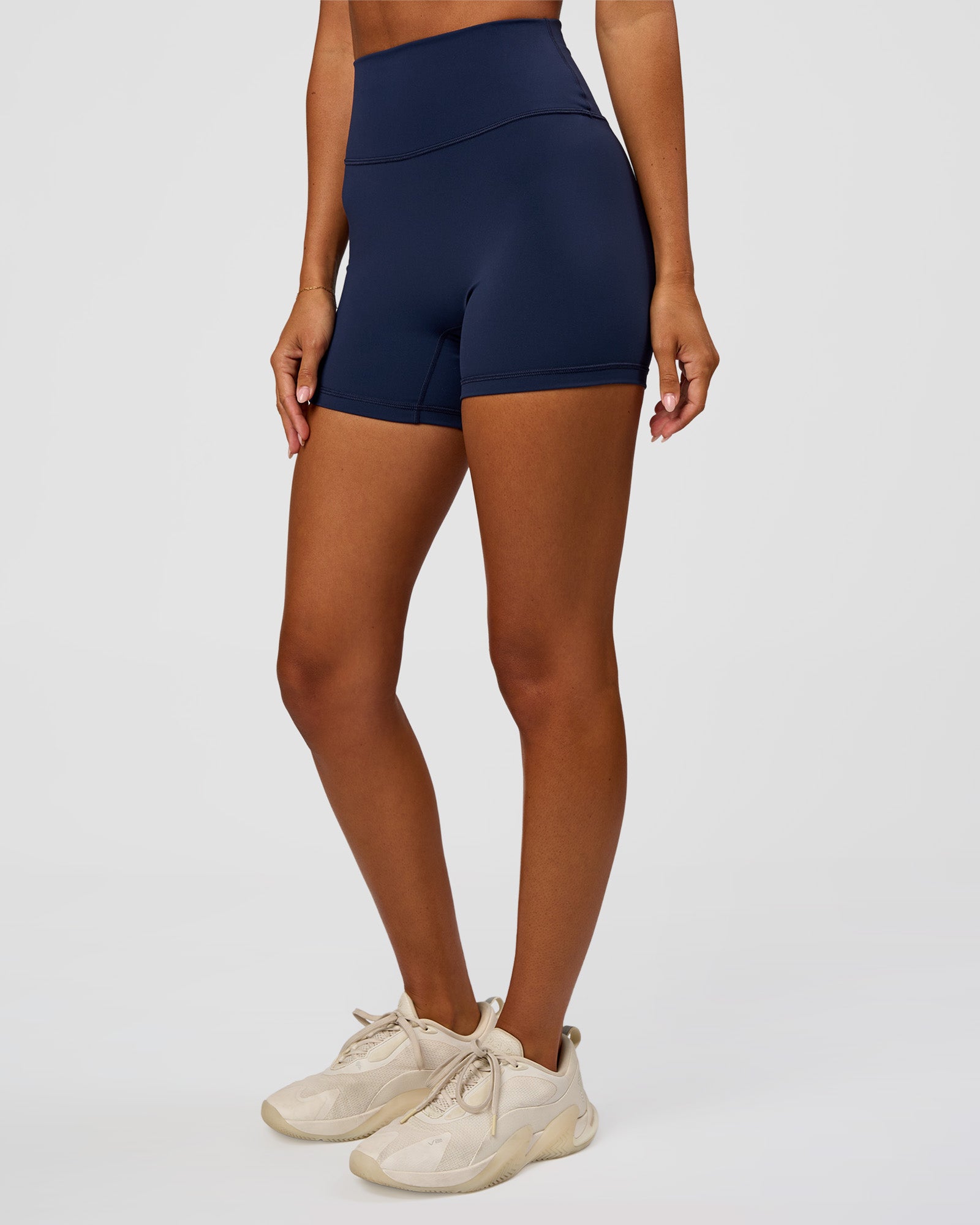 Woman wearing Fusion Ultra High-Rise 4" Short - Future Navy | Set:true | Angle:side | Model:Charli | Size:XS