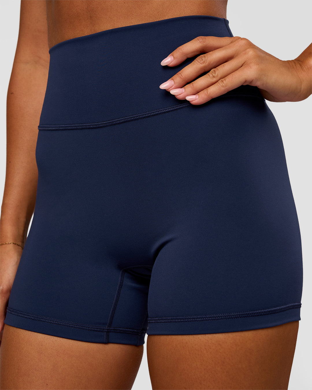 Woman wearing Fusion Ultra High-Rise 4" Short - Future Navy | Set:true | Angle:closeup | Model:Charli | Size:XS