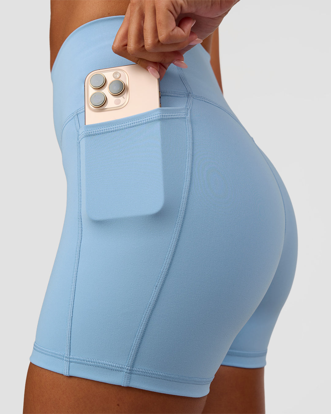Woman wearing Fusion Ultra High-Rise 4" Short Pockets - Open Air | Set:true | Angle:closeup | Model:Charli | Size:XS