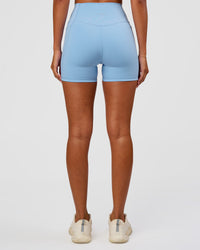 Woman wearing Fusion Ultra High-Rise 4" Short Pockets - Open Air | Set:true | Angle:back | Model:Charli | Size:XS