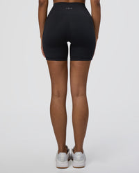 Woman wearing Fusion Ultra High-Rise 6" Short Pockets - Black | Set:true | Angle:back | Model:Jordan | Size:S