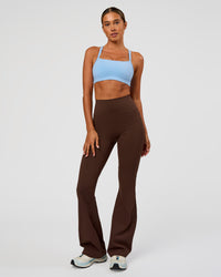 Woman wearing Fusion Ultra High-Rise Flared Legging Pockets - Hot Chocolate | Model:Charli | Size:XS