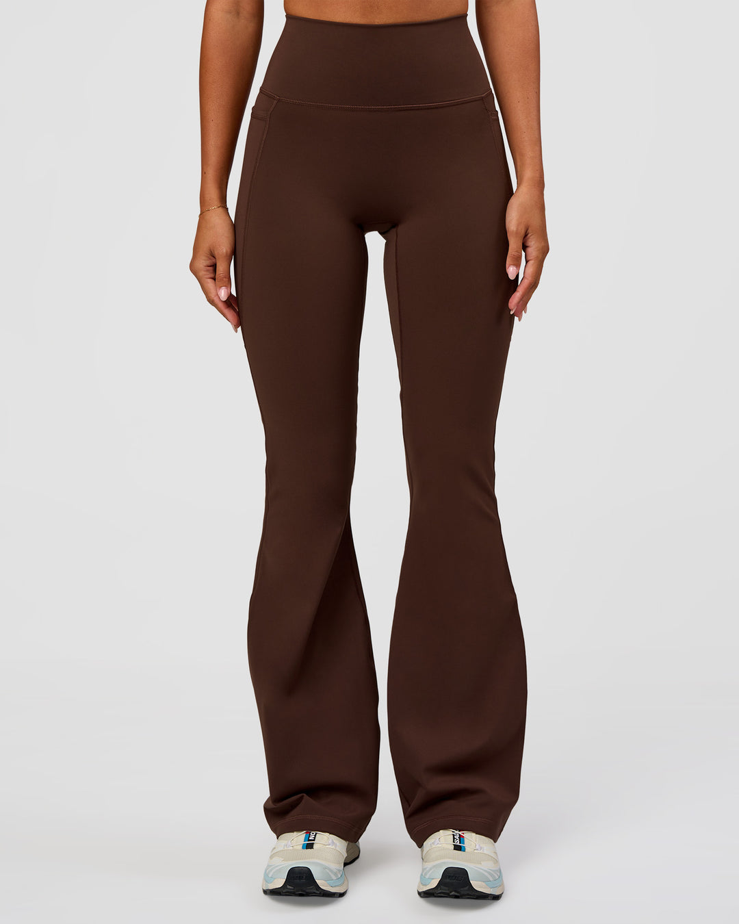 Woman wearing Fusion Ultra High-Rise Flared Legging Pockets - Hot Chocolate | Model:Charli | Size:XS