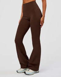 Woman wearing Fusion Ultra High-Rise Flared Legging Pockets - Hot Chocolate | Model:Charli | Size:XS