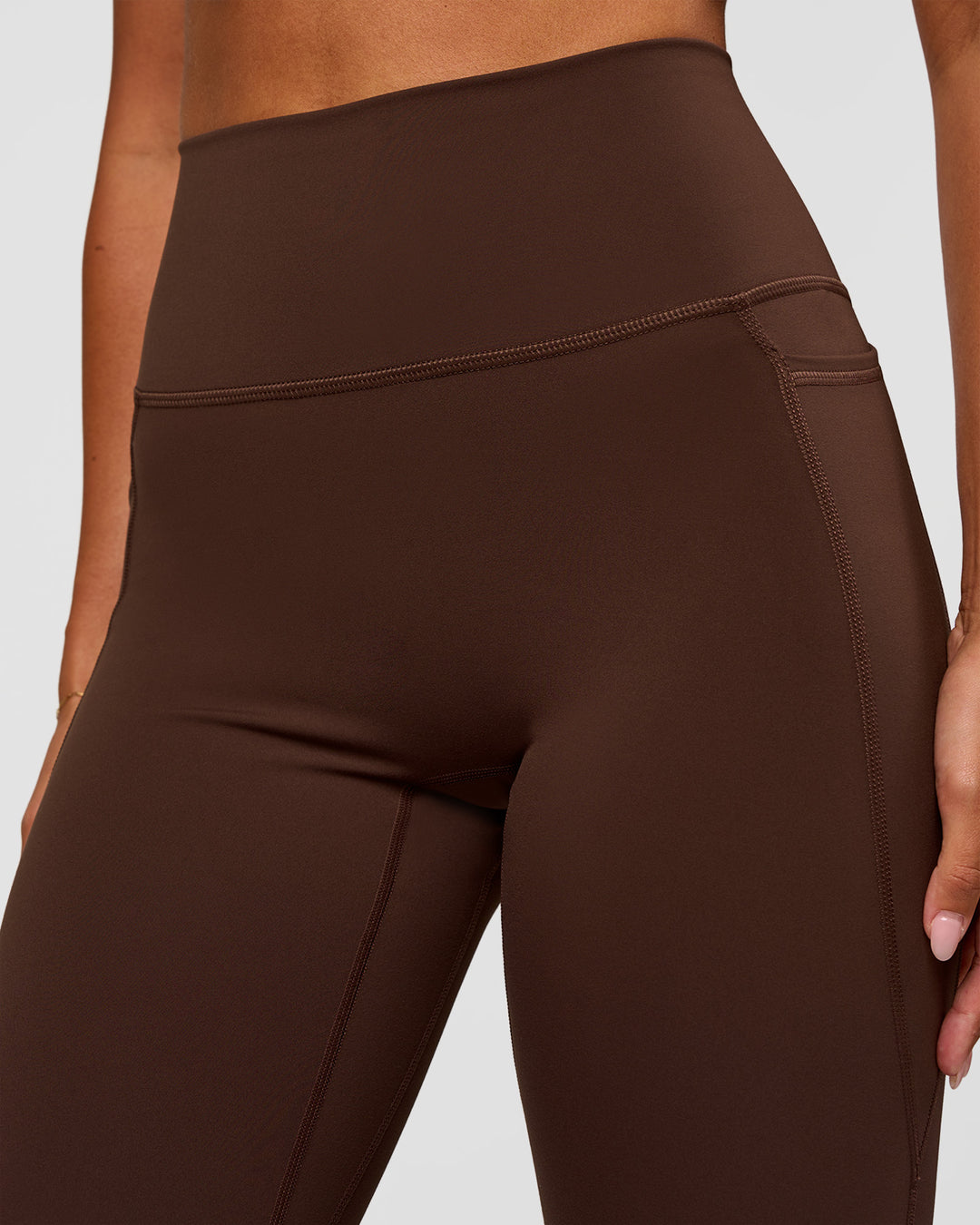 Woman wearing Fusion Ultra High-Rise Flared Legging Pockets - Hot Chocolate | Model:Charli | Size:XS