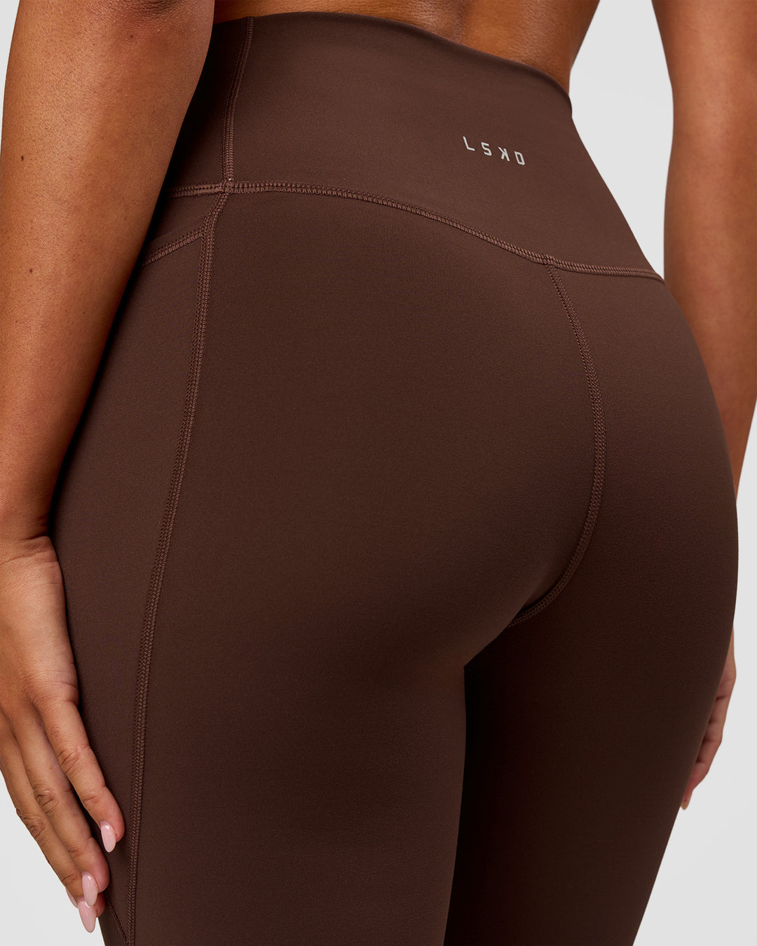 Woman wearing Fusion Ultra High-Rise Flared Legging Pockets - Hot Chocolate | Model:Charli | Size:XS