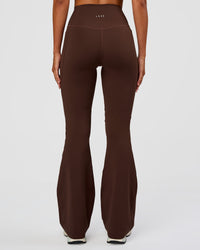 Woman wearing Fusion Ultra High-Rise Flared Legging Pockets - Hot Chocolate | Model:Charli | Size:XS