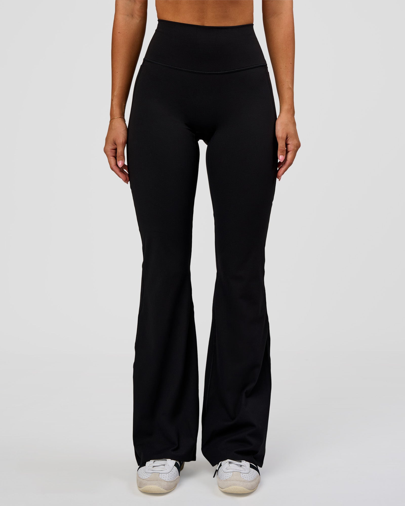 Woman wearing Fusion V-Contour High-Rise Flared Legging Pockets - Black | Model:Charli | Size:XS
