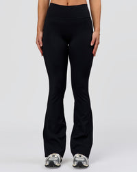 Woman wearing Fusion V-Contour High-Rise Flared Petite Legging Pockets - Black | Model:Issy | Size:XS