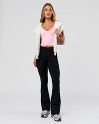 Woman wearing Fusion V-Contour High-Rise Flared Petite Legging Pockets - Black | Model:Issy | Size:XS