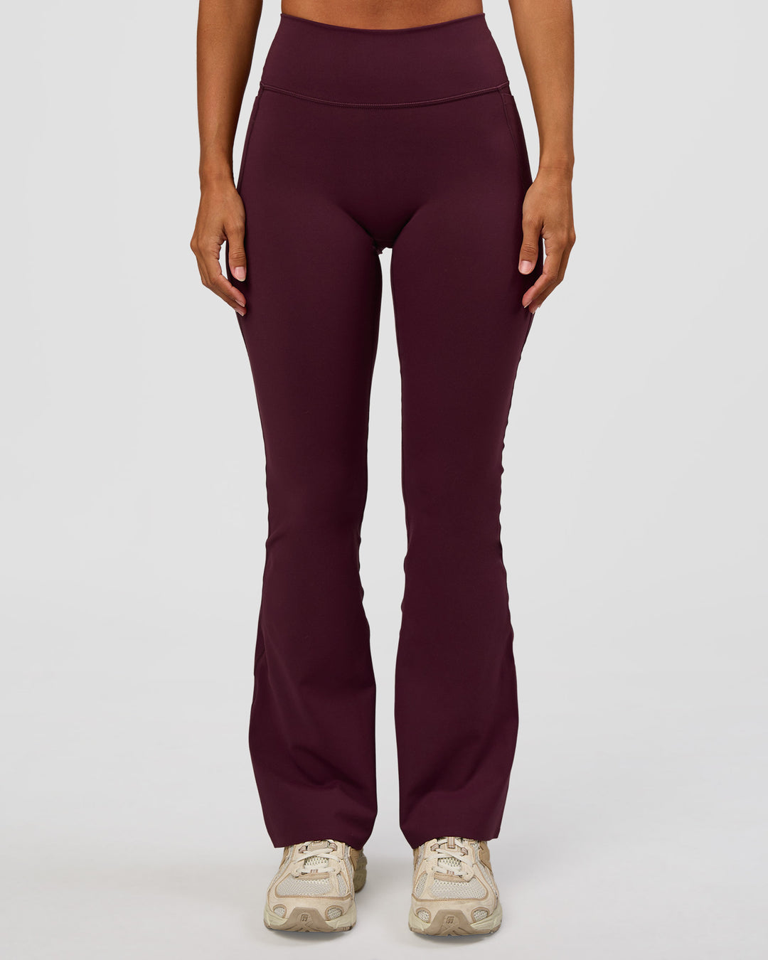 Woman wearing Fusion V-Contour High-Rise Flared Petite Legging Pockets - Cherry Lacquer | Model:Brylee | Size:XS