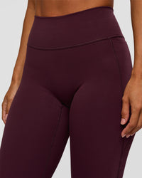 Woman wearing Fusion V-Contour High-Rise Flared Petite Legging Pockets - Cherry Lacquer | Model:Brylee | Size:XS