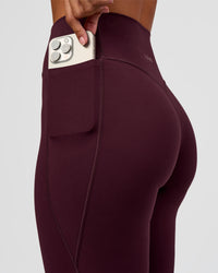 Woman wearing Fusion V-Contour High-Rise Flared Petite Legging Pockets - Cherry Lacquer | Model:Brylee | Size:XS