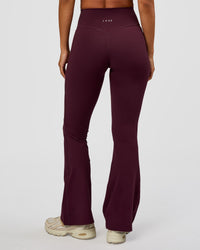 Woman wearing Fusion V-Contour High-Rise Flared Petite Legging Pockets - Cherry Lacquer | Model:Brylee | Size:XS