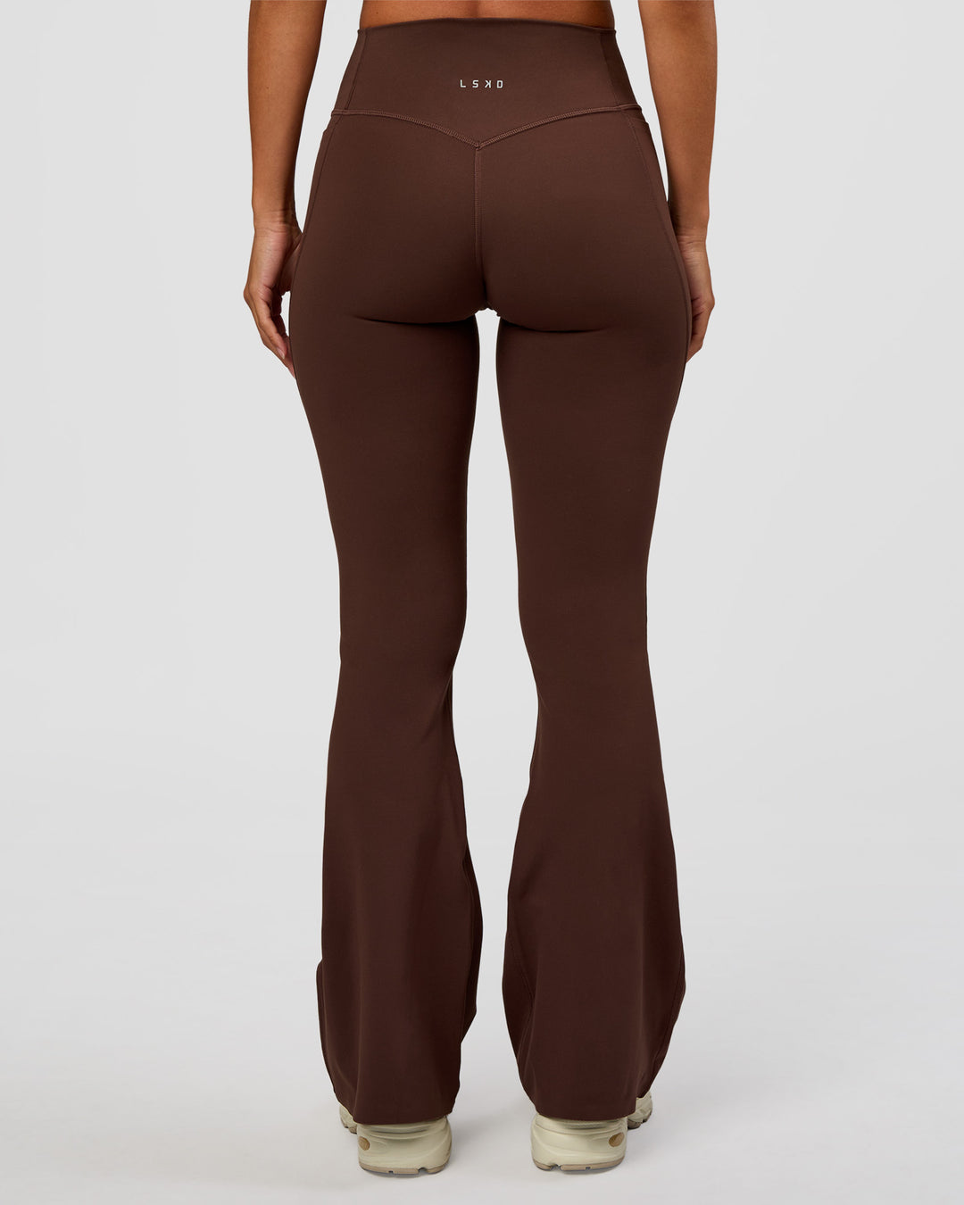Woman wearing Fusion V-Contour High-Rise Flared Petite Legging Pockets - Hot Chocolate | Model:Brylee | Size:XS