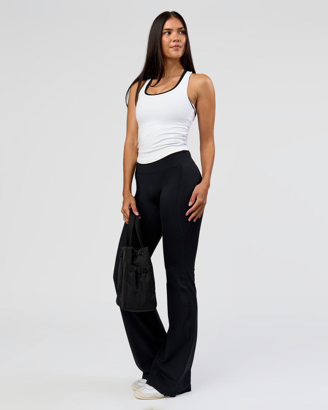 Woman wearing Fusion V-Contour High-Rise Flared Tall Legging Pockets - Black | Model:Rhiley | Size:S