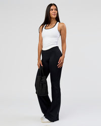 Woman wearing Fusion V-Contour High-Rise Flared Tall Legging Pockets - Black | Model:Rhiley | Size:S
