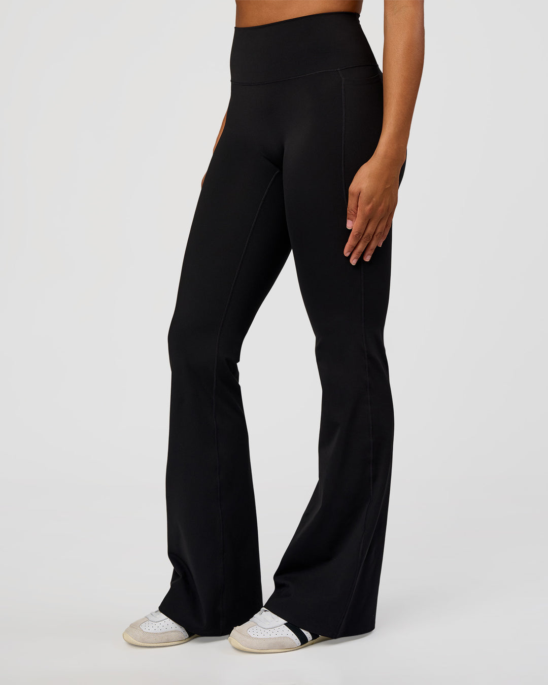 Woman wearing Fusion V-Contour High-Rise Flared Tall Legging Pockets - Black | Model:Rosie | Size:S