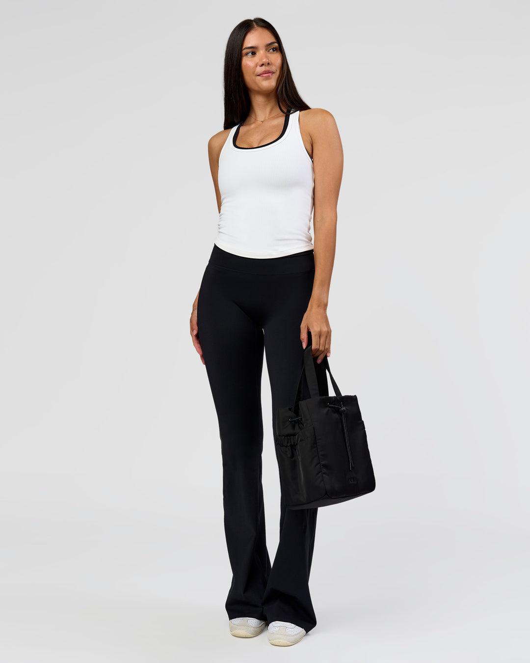 Woman wearing Fusion V-Contour High-Rise Flared Tall Legging Pockets - Black | Model:Rhiley | Size:S